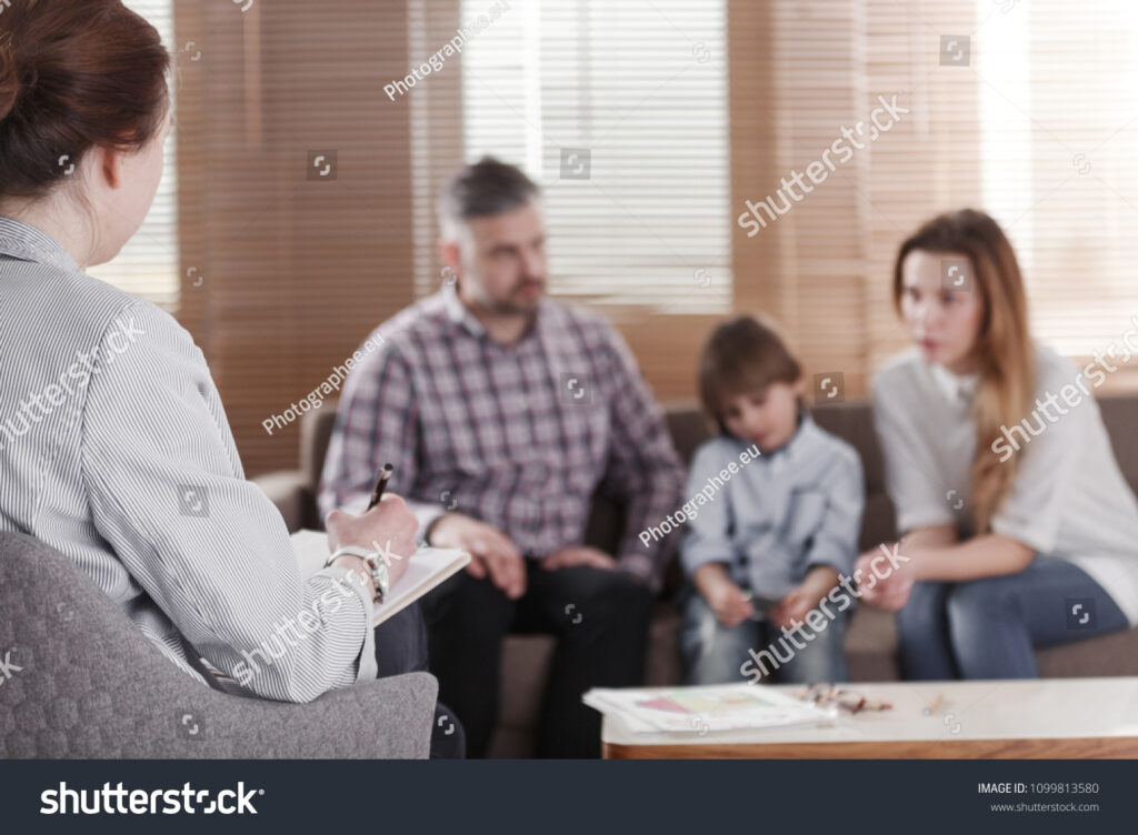 stock-photo-rear-view-of-female-psychologist-helping-young-family-with ...